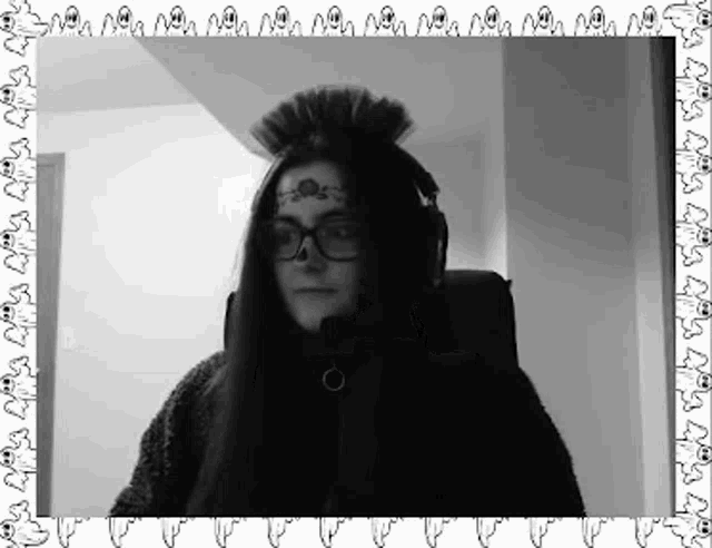 a black and white photo of a woman wearing a mohawk and glasses