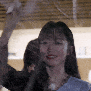 a close up of a woman 's face behind a glass window
