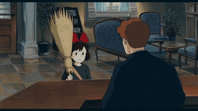 a girl with a broom on her head talks to a man in a suit