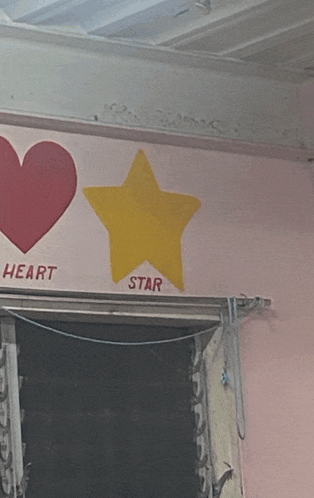 a heart and star are painted on a wall and the word ok is underlined