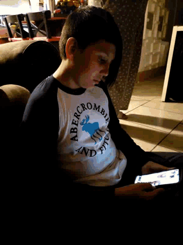 a young boy wearing a shirt that says abercrombie and fitch on it