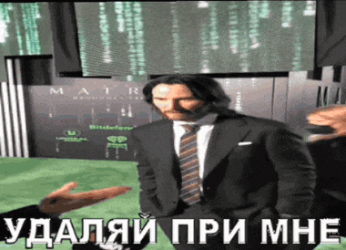 a man in a suit and tie is talking to another man in front of a screen that says matrix