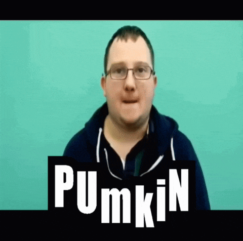 a man wearing glasses stands in front of a blue background with the word pumpkin on it
