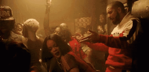 a man and a woman are dancing in a club with a crowd of people .