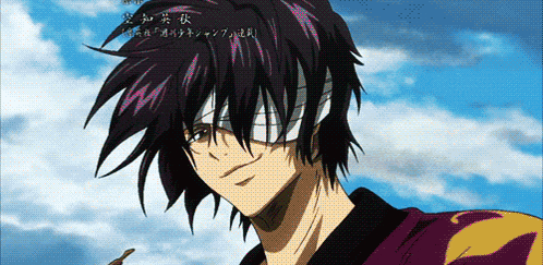 a man with a bandage on his eye is smiling in front of a blue sky