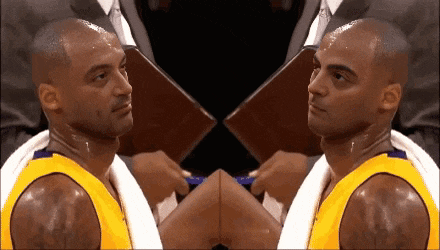 a basketball player with a towel around his neck is looking at the camera