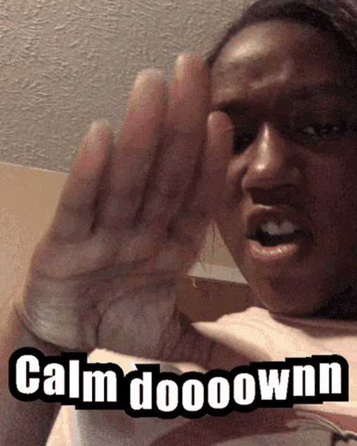 a woman with her hand up and the words calm dooownn