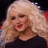 a woman with blonde hair and red lipstick is wearing a black shirt .
