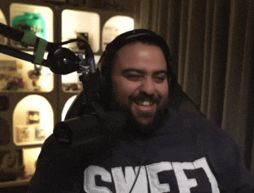 a man wearing headphones and a shirt that says ' sweep ' on it