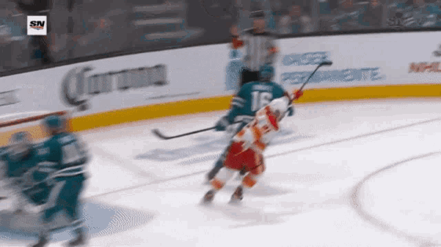 a hockey game is being played in front of an advertisement for corona