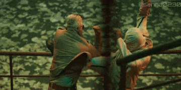 two men are fighting in a boxing ring and one of them is wearing a mask .