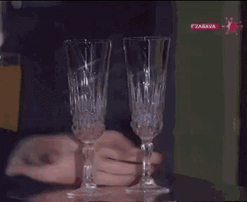 a hand is holding a glass with the word zabava on the bottom