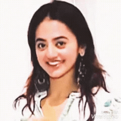 a close up of a woman 's face with a white background and a smile .