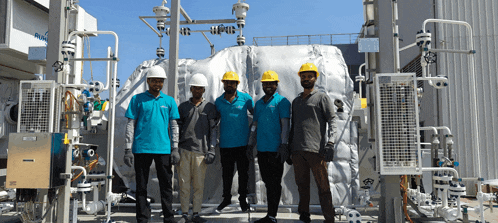 a group of men wearing hard hats are standing in front of a building that says flow