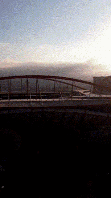 a bridge over a body of water at sunset