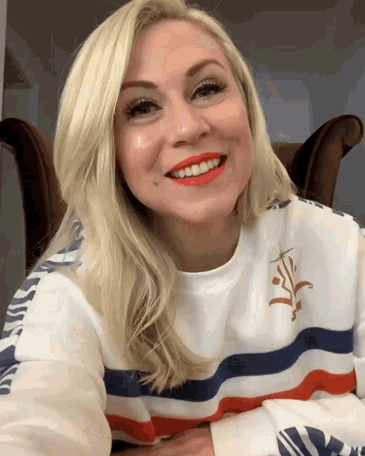 a woman wearing a red white and blue striped shirt with the word always on it