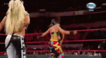 two women wrestling in a ring with a fox logo on the bottom