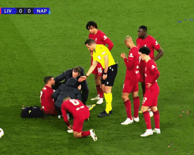 a group of soccer players on a field with a scoreboard that says liv 0 0 nap
