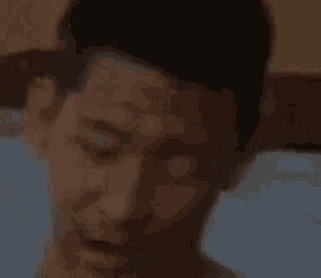 a close up of a man with his eyes closed and his mouth open .