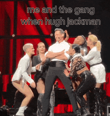 a group of women are standing around a man on a stage with a caption that says me and the gang when hugh jackman