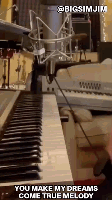 a person is playing a piano and singing into a microphone with the caption " you make my dreams come true melody "