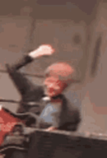 a blurry picture of a person holding a microphone in the air .