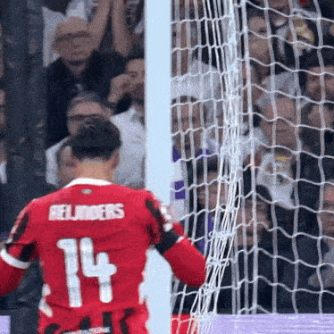 a soccer player with the number 14 on their jersey