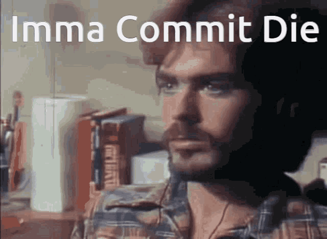 a man in a plaid shirt is sitting in front of a bookshelf with the words " imma commit die " on the bottom