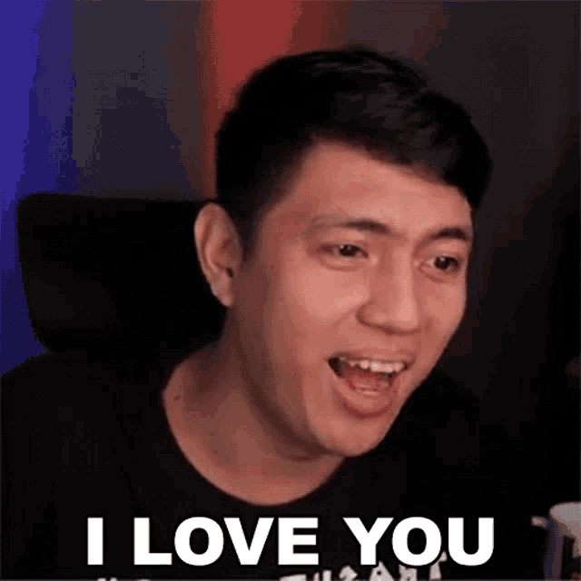 a man is making a funny face and saying i love you .