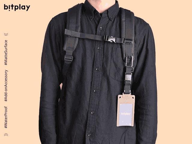 a man wearing a black shirt and a black backpack has a bitplay wallet attached to his back