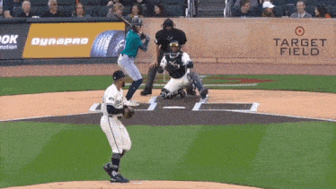 a baseball game is being played in front of an advertisement for target field