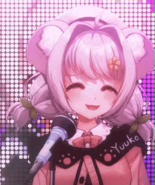 a girl with a microphone and the word yuuko on her sleeve