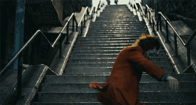 a person in a red suit is running up a set of stairs