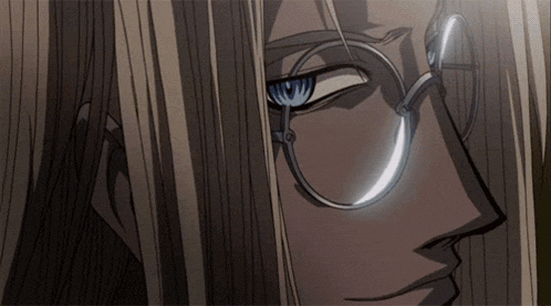 a close up of a man 's face with glasses and long hair