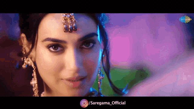 a close up of a woman 's face with the words / saregama_official below her