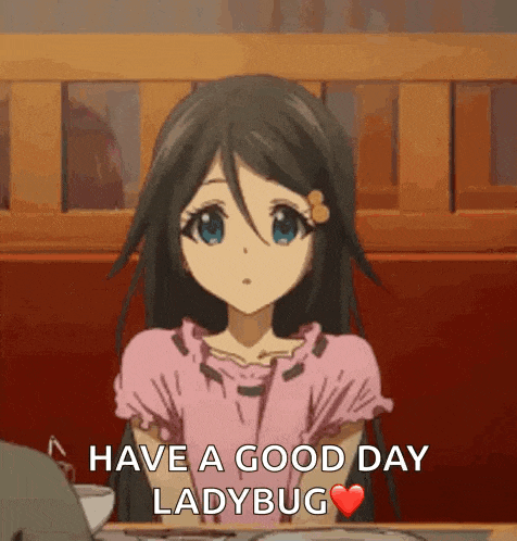 a girl in a pink dress is sitting at a table with the words `` have a good day ladybug '' written on it .