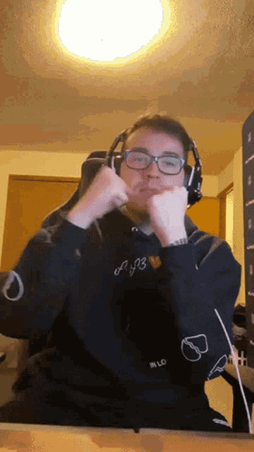 a man wearing headphones and a hoodie that says a03