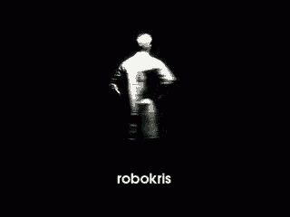 a man in a white shirt is standing in a dark room with the word robokris on the bottom