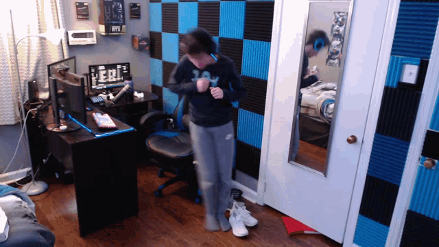 a person in a room with a sign that says ufc on the wall