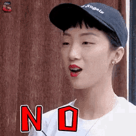 a woman wearing a hat and a white shirt says no in red letters