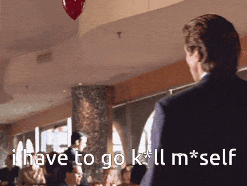 a man in a suit says i have to go kill m*self
