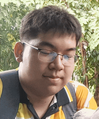 a man wearing glasses and a yellow and black striped shirt