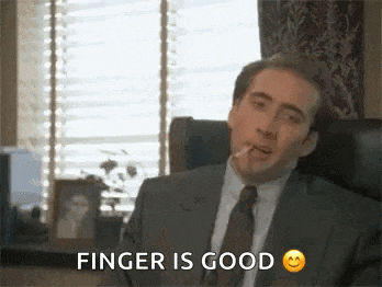 a man in a suit and tie is smoking a cigarette and says `` finger is good '' .
