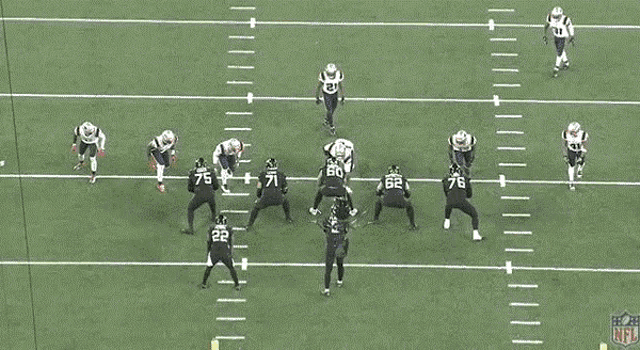 a group of football players are running on a field with the nfl logo on the sidelines
