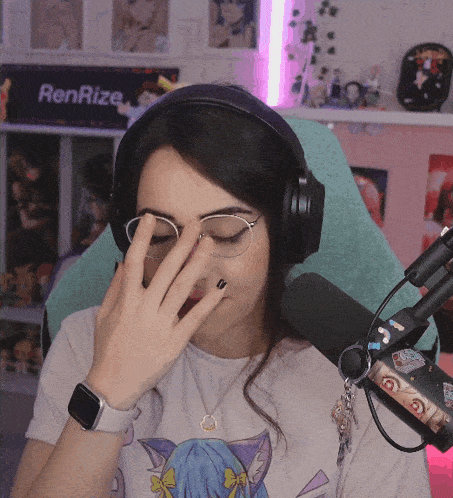 a woman wearing headphones and a watch covering her face in front of a sign that says renrize