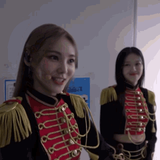 two women in military uniforms are standing next to each other smiling