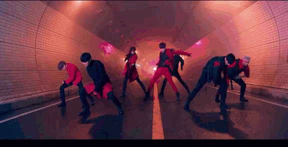 a group of people are dancing in a tunnel .