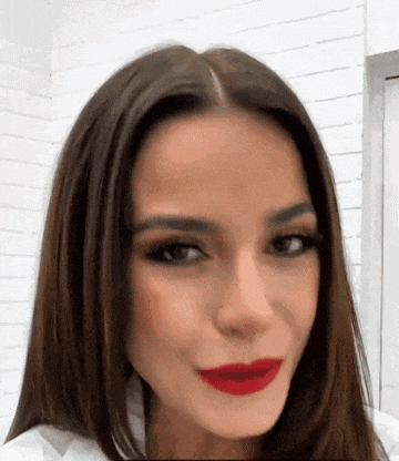 a close up of a woman 's face with red lipstick on her lips