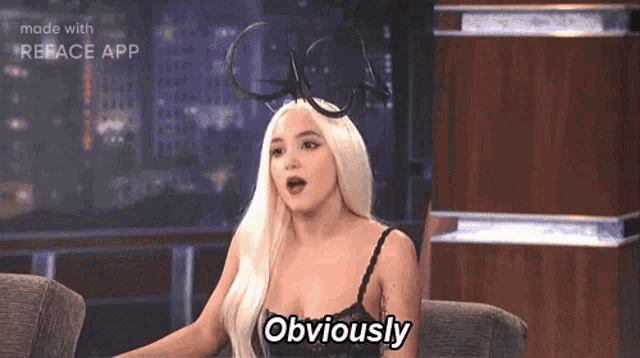 a woman in a black bra is sitting in a chair and says obviously .