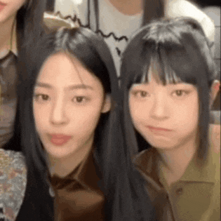 a group of young girls are posing for a picture together and making funny faces .